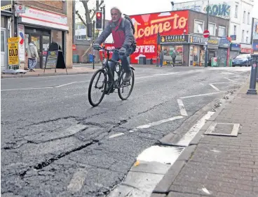  ?? PHOTOGRAPH: JONATHAN MYERS ?? A cyclist negotiates the cracked road surface on Dalby Avenue in Bedminster