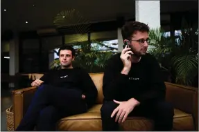  ?? (AP/Alberto Pezzali) ?? Co-founders of the app Stint, brothers Sam (left) and Sol Schlagman, sit on a couch, at their headquarte­rs in Camden, London.