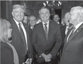  ?? ALAN SANTOS/AP ?? Brazil’s President Jair Bolsonaro, center, smiles with President Donald Trump, second from left, and Vice President Mike Pence, right, during a March 7 dinner at Trump’s Mar-a-Lago resort in Florida.