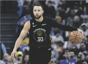  ?? JEFF CHIU/AP ?? GOLDEN STATE WARRIORS GUARD STEPHEN CURRY (30) brings the ball up the court against the Milwaukee Bucks during the first half of a game in San Francisco on Saturday.