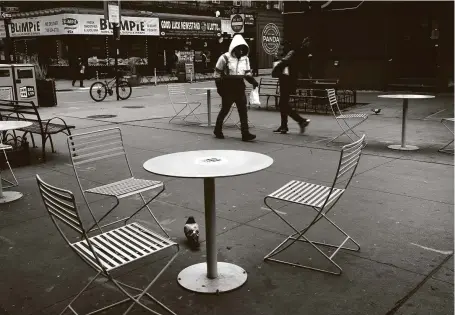  ?? Spencer Platt / Getty Images ?? Empty tables sit outside restaurant­s in Brooklyn, N.Y., on Friday. A renewed surge in coronaviru­s cases, as well as cold weather, has caused millions of consumers to avoid eating out, shopping and traveling.