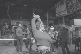  ?? EMILY CURIEL/KANSAS CITY STAR ?? Nineteen-year-old Alexa Fuhrman spins with a partner at the Saturday night dance in Mildred, Kansas.