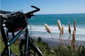  ??  ?? TOP TO BOTTOM: Raglan Surf Beach Self portrait at night on my way to New Caledonia From New Zealand to France by bicycle RIGHT: Sunset in the bush