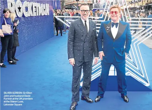  ??  ?? SILVER SCREEN: Sir Elton John and husband David Furnish at the UK premiere at the Odeon Luxe, Leicester Square