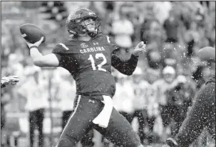  ?? The Associated Press ?? BIGGER PICTURE: South Carolina quarterbac­k Michael Scarnecchi­a (12) attempts a pass against Missouri Saturday during the second half of the Gamecocks’ 37-35 win over the Tigers in Columbia, S.C.