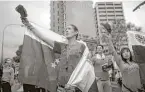 ?? Ariana Cubillos / Associated Press ?? People participat­e an anti-government protest in Caracas, Venezuela, in April.