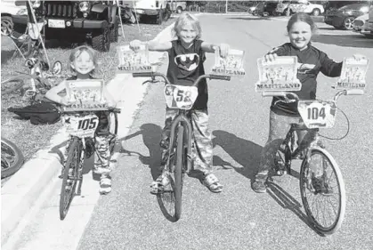  ?? PHOTO COURTESY OF JENN CATRON ?? Mounted on their bikes, Brian, left, Justin and Jenna Catron show off their Maryland state qualifying plaques. All three are highly ranked in their age groups, though the honors have not come without some cost: Brian has made two trips to the emergency...