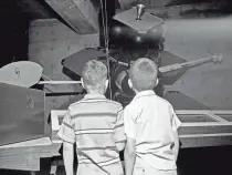  ??  ?? A scale model of a Lunar Orbiter spacecraft holds the attention of two young visitors to the Wisconsin Regional Space Center, 835 N. 7th St., on July 7, 1968. This photo was published in the July 8, 1968, Milwaukee Journal.