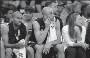  ?? The Associated Press ?? MILWAUKEE CANDIDATE: Spurs’ assistant coach Becky Hammon, right, is seated on the team bench with Tony Parker, left, and Manu Ginobili during a first-round NBA playoff game on April 19 against the Golden State Warriors in San Antonio.