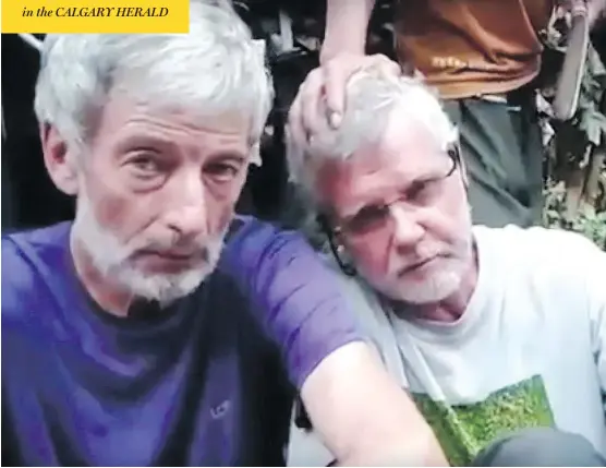  ?? YOUTUBE ?? Robert Hall, left, and John Ridsdel, as seen in a video released after they were abducted Sept. 21 in the Philippine­s. A plastic bag containing Ridsdel’s head was found Monday.