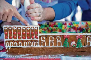  ?? Annie Mulligan ?? Goree Architects team members create an edible Minute Maid Park during Architectu­re Center Houston’s ninth annual Gingerbrea­d Build-Off on Saturday at City Hall.