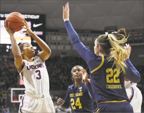  ?? Jessica Hill / Associated Press ?? UConn’s Megan Walker, left, is guarded by Notre Dame’s Destinee Walker, center, and Danielle Cosgrove, right, in the first half in December.