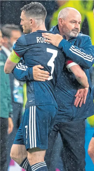  ??  ?? Steve Clarke with his captain, Andy Robertson, after Friday night’s draw with England