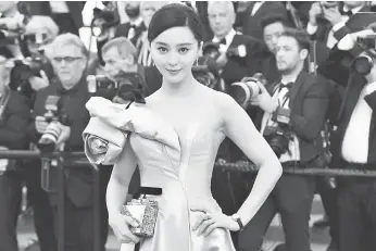  ?? — Gambar AFP ?? SKANDAL CUKAI: Gambar fail yang diambil pada 11 Mei 2018 ini menunjukka­n aktres China Fan Bingbing semasa tiba untuk tayangan perdana filem ‘Ash is Purest White (Jiang hu er nv)’ di edisi ke- 71 Festival Filem Cannes di Cannes, selatan Perancis France.