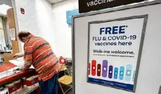  ?? Nam Y. Huh/Associated Press ?? A sign for flu and covid vaccinatio­ns is displayed at a pharmacy store in Palatine, Ill., Sept. 13.