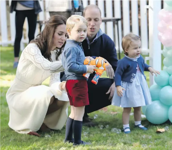  ?? — GETTY IMAGES ?? Catherine, Duchess of Cambridge, son Prince George, Prince William, Duke of Cambridge and daughter Princess Charlotte enjoy a children’s party Thursday in Victoria for military families during the Royal Tour.