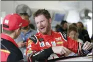  ?? TERRY RENNA — THE ASSOCIATED PRESS ?? Dale Earnhardt Jr. shares a laugh with a crew member after practice for Sunday’s NASCAR Cup Series auto race at Homestead-Miami Speedway in Homestead, Fla., Saturday, Nov. 18, 2017.