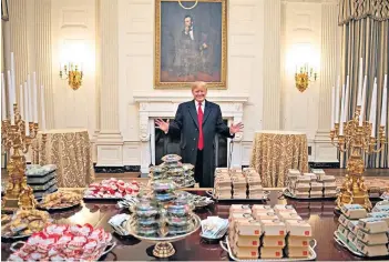  ?? ?? President Trump in front of a fast-food feast for the victorious Clemson Tigers football team in 2019
