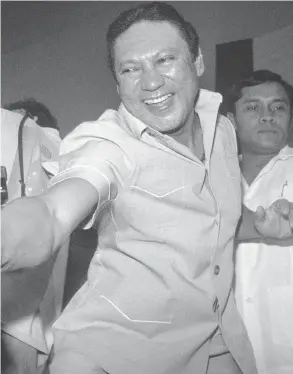  ?? CARLOS SCHIEBECK / AFP / GETTY IMAGES ?? General Manuel Antonio Noriega shakes the hands of followers in Panama City in 1988. The Panamanian strongman, who was ousted by U.S. forces in 1989, died late Monday.