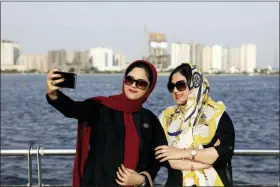  ?? EBRAHIM NOROOZI — THE ASSOCIATED PRESS ?? In this Saturday photo, Iranians take selfie around of the Persian Gulf Martyrs lake, west of Tehran, Iran. A few daring women in Iran’s capital have been taking off their mandatory headscarve­s, or hijabs, in public, risking arrest and drawing the ire of hard-liners. Many others stop short of outright defiance and opt for loosely draped scarves that show as much hair as they cover. More women are pushing back against the dress code imposed after the 1979 Islamic Revolution, and activists say rebelling against the hijab is the most visible form of anti-government protest in Iran today. Those with economic grievances frequently protest.
Alinejad, the activist, argued the campaign against forced hijabs carries symbolic weight, saying that mandatory headscarve­s were “the symbol that the Iranian government used to take the whole society hostage.”
In recent years, she has posted videos and photos of activists, including of