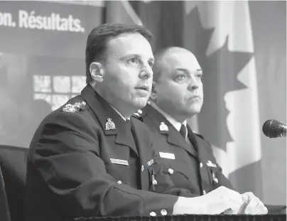  ?? PATRICK DOYLE / THE CANADIAN PRESS ?? RCMP Assistant Commission­er James Malizia, left, and Insp. Paul Mellon speak about the arrest of a Somali man, Ali Omar Ader, for his involvemen­t in the kidnapping of Canadian journalist Amanda Lindhout in Somalia in 2008.
