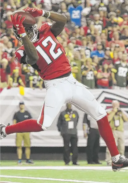  ?? | RAINIER EHRHARDT/ AP ?? The Falcons’ Mohamed Sanu hauls in the winning touchdown pass with 31 seconds left, capping a 75- yard march.