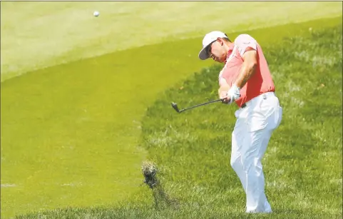  ?? Jeff Roberson / Associated Press ?? Gary Woodland hits to the eighth green during the second round of the PGA Championsh­ip at Bellerive Country Club on Friday.