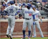  ?? SETH WENIG — THE ASSOCIATED PRESS ?? Los Angeles Dodgers’ Cody Bellinger, left, celebrates his home run with Yasiel Puig during the fourth inning of a baseball game against the New York Mets at Citi Field Sunday in New York.