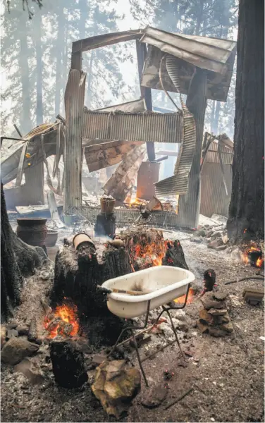  ?? Peter DaSilva / Special to The Chronicle ?? Embers still glow at a burned house on Mount Veeder Road in Napa County after flames from the Nuns Fire scorched the area. The blaze joined the Norrbom Fire and combined consumed nearly 15,000 acres.