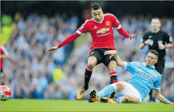  ?? — THE ASSOCIATED PRESS FILES ?? United’s Jesse Lingard, left, and Manchester City’s Martin Demichelis challenge for the ball during a match Sunday.
