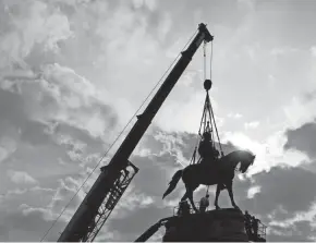  ?? STEVE HELBER/AP ?? Virginia officials plan to leave the Robert E. Lee statue pedestal in place, at least for now, with the expectatio­n that a community-involved rethinking of Richmond’s Monument Avenue will kick off soon.