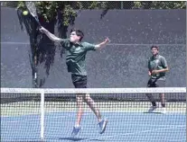  ?? ?? FAR LEFT: Playing in the CIF South Area Tournament in Bakersfiel­d, Nick Siebold looks to put away an overhead volley at the net while Laksha Prajapati looks on from the baseline.