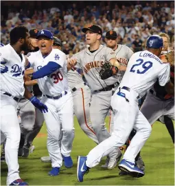  ?? (Reuters) ?? THE BENCHES clear in a brawl between the Los Angeles Dodgers and the San Francisco Giants in the seventh inning of their contest on Tuesday night. The incident led to the ejection of Los Angeles right fielder Yasiel Puig and San Francisco catcher Nick Hundley in a game the visiting Giants pulled out a 2-1 victory.