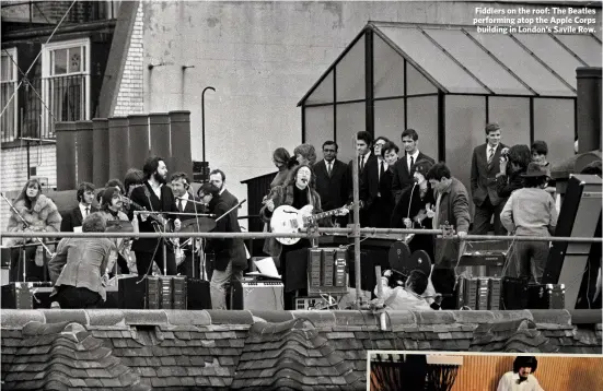  ??  ?? Fiddlers on the roof: The Beatles performing atop the Apple Corps
building in London’s Savile Row.