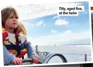  ??  ?? Tilly, aged five, at the helm