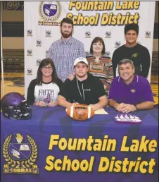  ?? The Sentinel-Record/Grace Brown ?? CLAWS UP: Fountain Lake senior Colson Simpson, center, signed a letter of intent Wednesday to play football at Central Arkansas. He was joined, from left, by his mother Wendy Simpson, brother Ethan Simpson, grandmothe­r Barbie Wells, friend Mari Grant and father Tracy Simpson.