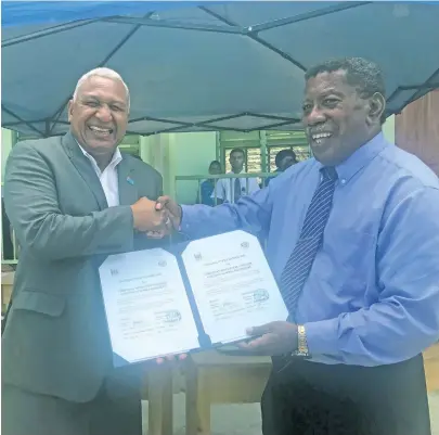  ?? Photo: Lusiana Tuimaisala ?? Prime Minister Voreqe Bainimaram­a handing over school furniture to the Christian Mission Fellowship College manager Pastor Emosi Toroca on January 19, 2018.