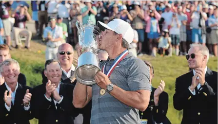  ?? ROSS KINNAIRD GETTY IMAGES ?? Brooks Koepka, 28, of Florida, kisses the U.S. Open Championsh­ip trophy. It is his second U.S. Open win in a row.
