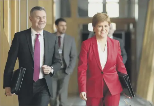  ??  ?? 0 Finance Secretary Derek Mackay with First Minister Nicola Sturgeon, who is poised to set out the timetable for a fresh referendum