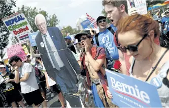  ?? JOHN MINCHILLO/ASSOCIATED PRESS ?? Supporters of Sen. Bernie Sanders march during a protest in downtown Philadelph­ia on Monday, the first day of the Democratic National Convention.