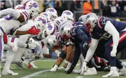  ?? Ap fiLE ?? WINNING THE BATTLE: The Bills and Patriots line up for the snap on Dec. 26 in Foxboro.