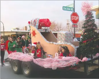  ?? Westside Eagle Observer/SUSAN HOLLAND ?? The float from Dynamic Rhythm Dance Studio, with its gaily decorated tree and a sleigh carrying gifts, attracted much attention in the Gravette Christmas parade. The float received the trophy for most festive entry in the parade and was followed by a group of tap dancers who showed off some of their dance steps.