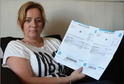  ?? Photo by Domnick Walsh ?? Lynda McCarthy, Abbeydorne­y, with her two water bills.