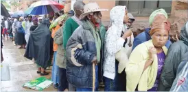  ??  ?? People queue for money at a local bank in Bulawayo in this file picture