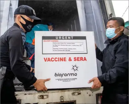  ?? REUTERS ?? A box of COVID-19 vaccine produced by China’s Sinovac Biotech is unloaded, after arriving on Jan 4, at the local health department in Palembang, the capital of Indonesia’s South Sumatra province. Indonesia plans to distribute the Sinovac vaccine to all of its 34 provinces.