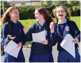  ??  ?? Chloe King, Lillie Waterhouse, and Elaina Kondrtivea celebrate at Malahide Community School. Photo: Tony Gavin