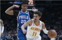  ?? CHRIS SZAGOLA – THE ASSOCIATED PRESS ?? Atlanta’s Trae Young, right, pushes the ball toward the basket Monday night against Sixers guard Markelle Fultz at Wells Fargo Center.