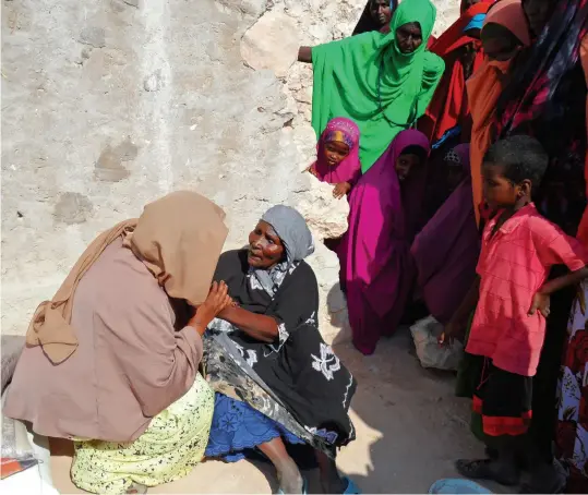  ??  ?? ABOVE Drought has taken a heavy toll in Somalia: here, an elderly woman tells Sahra that her family has not only lost their animals, but that her son has died too, leaving her to care for her grandchild­ren.