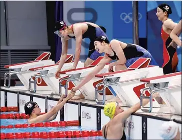  ?? Oodd Andersen AFP via Getty Images ?? RIKAKO IKEE, center, and her Japanese teammates Chihiro Igarashi, right, Natsumi Sakai and Rika Omoto, bottom left, finish their heat in the freestyle relay, in which they came in fifth.