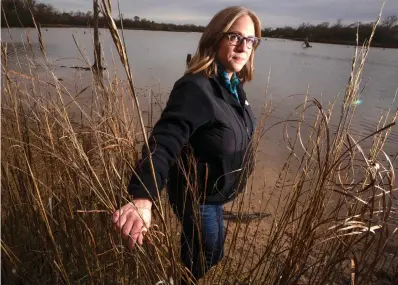  ?? Stuart Villanueva photos/The Galveston County Daily News via AP ?? ■ ABOVE: Jordan Macha, executive director of Bayou City Waterkeepe­r, a Houston-based group with a history of monitoring Clean Water Act violations, poses for a photo Feb. 2 near Galveston, Texas. ■ BELOW: An egret wades through tall grasses Feb. 2 on a stretch of wetland along Interstate 45 near Galveston.